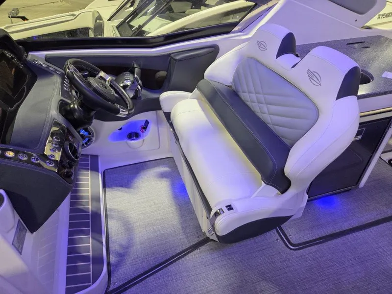 Slide: The Image of 2022 Chaparral 347 SSX boat interior with modern dashboard and luxurious seating. - 7