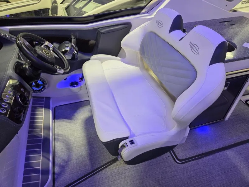 Slide: The Image of 2022 Chaparral 347 SSX boat interior with white captain's seat and steering wheel. - 8