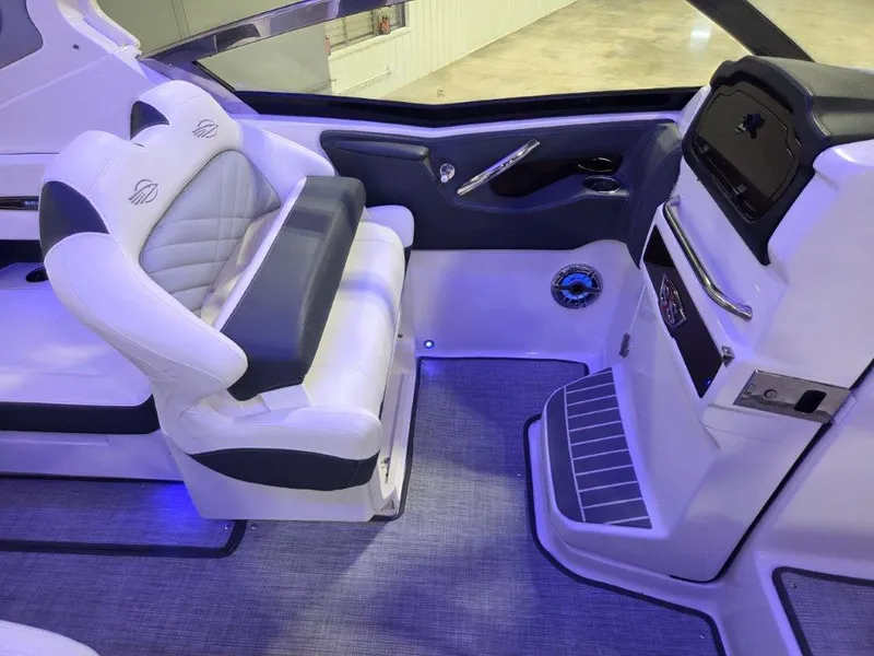 Slide: The Image of 2022 Chaparral 347 SSX boat interior with white seating and modern dashboard. - 9