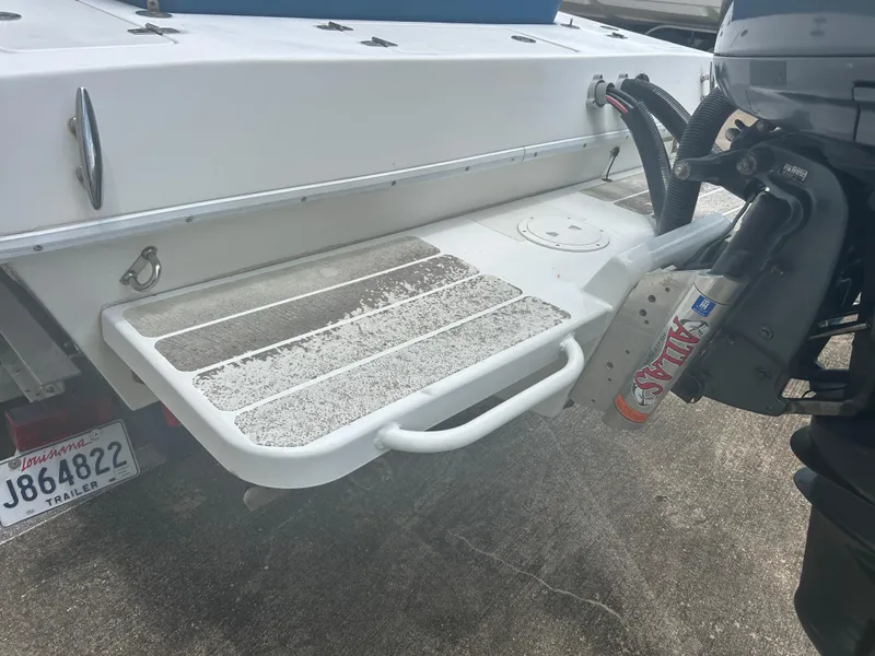 Slide: The Image of Boat stern with motor, Concept 23 CC, 2001 model, Louisiana trailer plate visible. - 13