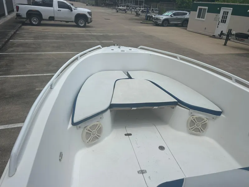 Slide: The Image of Open deck of a 2001 Concept 23 CC boat in a parking lot. - 16