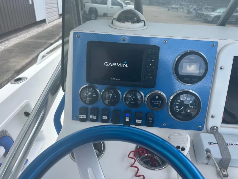 Slide: The Image of Boat dashboard with Garmin GPS, gauges, and blue steering wheel, Concept 23 CC, 2001 model. - 20