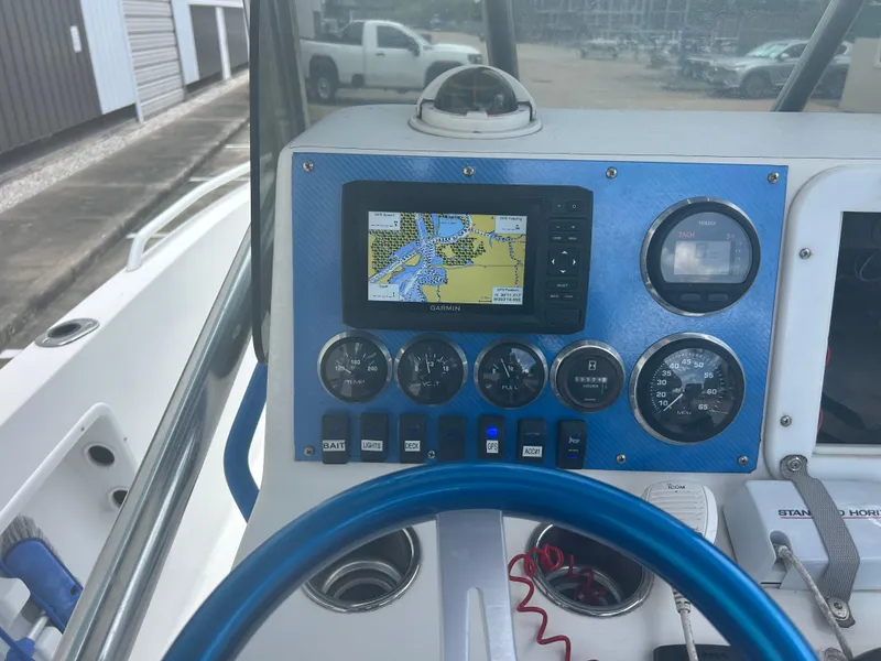 Slide: The Image of Boat dashboard with Garmin GPS, gauges, and blue steering wheel, Concept 23 CC, 2001 model. - 23