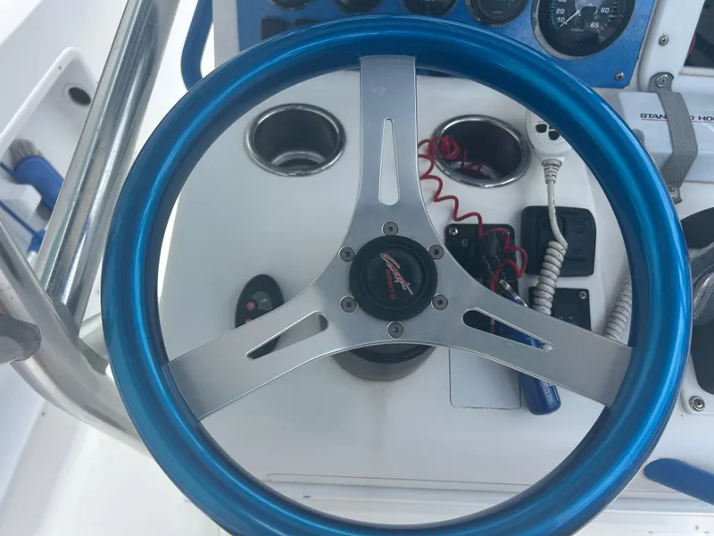 Slide: The Image of Steering wheel of 2001 Concept 23 CC boat with blue rim and control panel. - 28