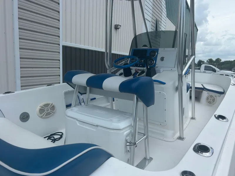 Slide: The Image of 2001 Concept 23 CC boat interior with blue and white seating, steering console, and storage. - 5