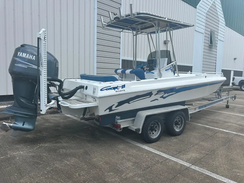 Slide: The Image of 2001 Concept 23 CC boat on trailer with Yamaha outboard motor, parked outside a building. - 6