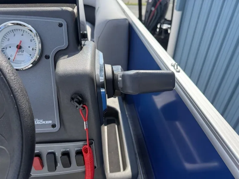 Slide: The Image of Close-up of 2026 Sun Tracker PARTY BARGE® 16 DLX dashboard with RPM gauge and controls. - 11