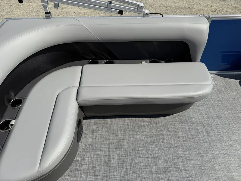 Slide: The Image of 2026 Sun Tracker PARTY BARGE® 16 DLX interior with gray seating and cup holders. - 12