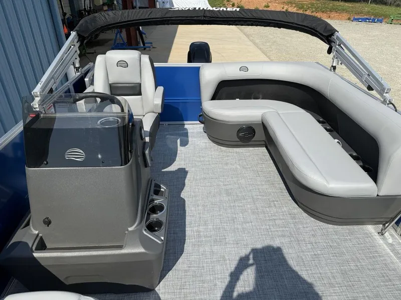 Slide: The Image of 2026 Sun Tracker PARTY BARGE® 16 DLX pontoon boat with gray seating and helm. - 14