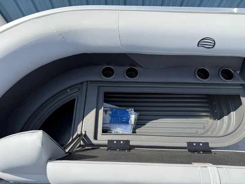 Slide: The Image of 2026 Sun Tracker PARTY BARGE® 16 DLX storage compartment with cup holders and seating. - 15