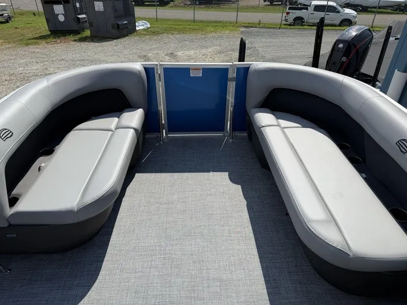 Slide: The Image of 2026 Sun Tracker PARTY BARGE® 16 DLX interior with gray seating and open deck space. - 6