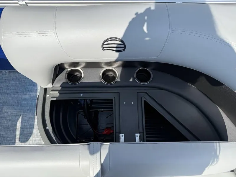 Slide: The Image of 2026 Sun Tracker PARTY BARGE® 16 DLX seating area with cup holders and storage compartment. - 8