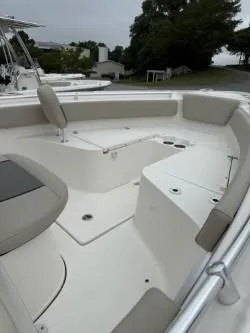 Slide: The Image of 2025 Key West 239 FS boat interior with cushioned seating and storage compartments. - 4