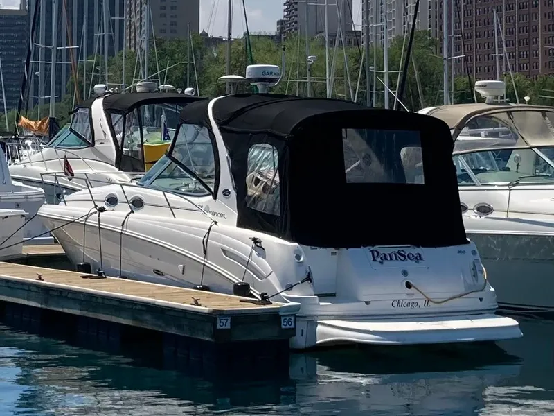 Slide: The Image of 2002 Sea Ray 300 Sundancer docked in a marina, Chicago skyline in background. - 3