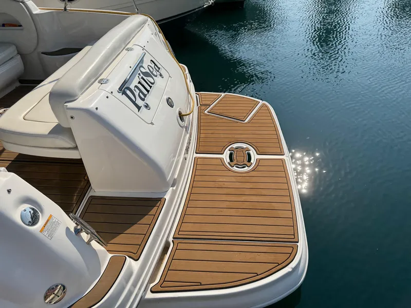 Slide: The Image of 2002 Sea Ray 300 Sundancer swim platform with teak decking, reflecting sunlight on water. - 4