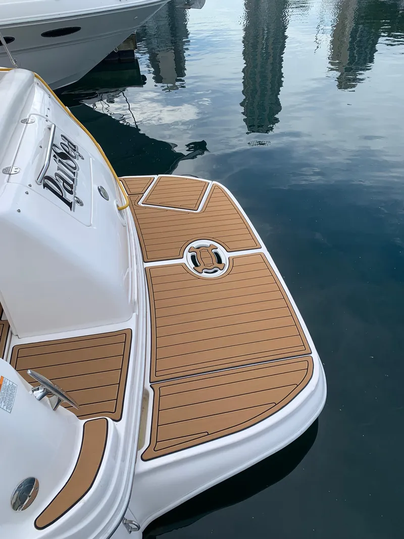 Slide: The Image of 2002 Sea Ray 300 Sundancer swim platform with teak-style decking at marina. - 5