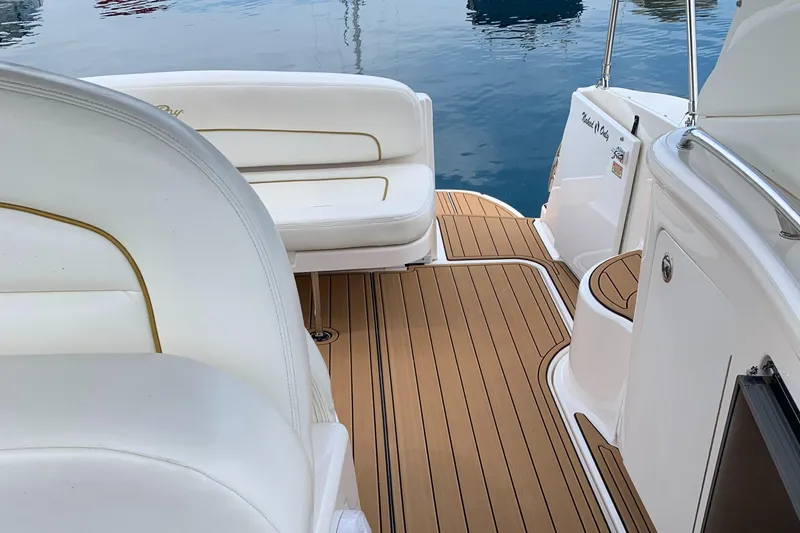 Slide: The Image of Luxurious 2002 Sea Ray 300 Sundancer boat interior with teak flooring and white seating. - 6