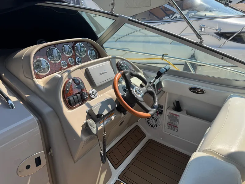 Slide: The Image of Cockpit of 2002 Sea Ray 300 Sundancer with steering wheel and Garmin navigation system. - 8