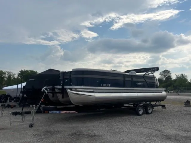 Slide: The Image of 2020 Crest Classic DLX 240 SLC pontoon boat on trailer under cloudy sky. - 16
