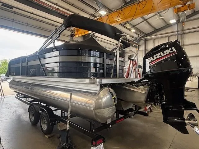 Slide: The Image of 2020 Crest Classic DLX 240 SLC pontoon boat with Suzuki outboard motor in a garage. - 22