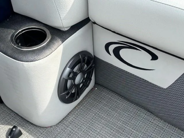 Slide: The Image of 2020 Crest Classic DLX 240 SLC boat interior with speaker and cup holder. - 25