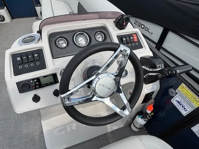 Slide: The Image of Steering console of 2020 Crest Classic DLX 240 SLC boat with gauges and controls. - 27