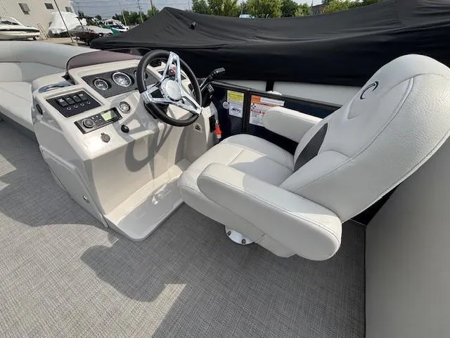 Slide: The Image of 2020 Crest Classic DLX 240 SLC boat interior with steering wheel and captain's chair. - 3