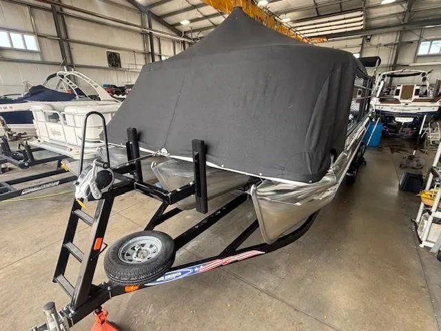 Slide: The Image of 2020 Crest Classic DLX 240 SLC pontoon boat covered in a storage facility. - 30