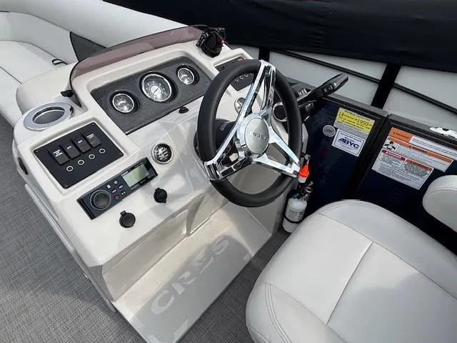 Slide: The Image of 2020 Crest Classic DLX 240 SLC boat dashboard with steering wheel and controls. - 4