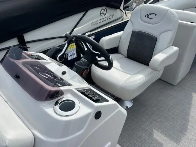 Slide: The Image of Captain's seat and helm of 2020 Crest Classic DLX 240 SLC boat, featuring modern controls. - 5