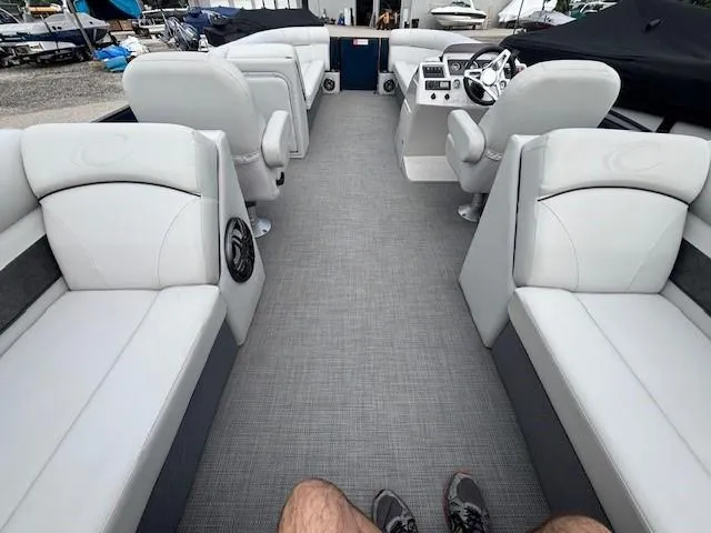 Slide: The Image of 2020 Crest Classic DLX 240 SLC pontoon boat interior with plush seating and modern dashboard. - 7