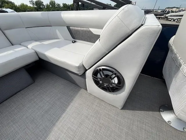 Slide: The Image of 2020 Crest Classic DLX 240 SLC boat interior with gray seating and speaker. - 8