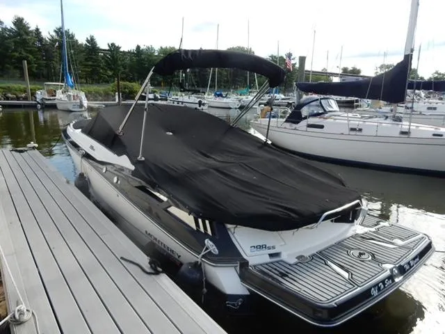Slide: The Image of 2014 Monterey 288 Super Sport boat docked with black cover in marina. - 12