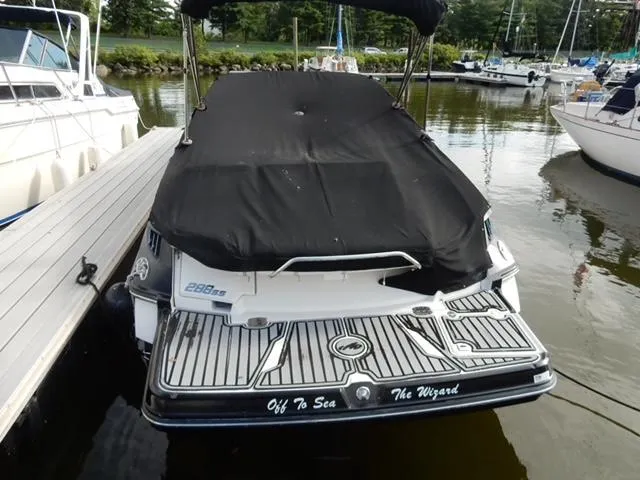 Slide: The Image of 2014 Monterey 288 Super Sport boat docked with cover, rear view. - 14