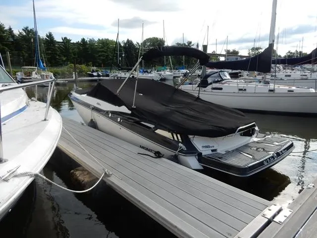Slide: The Image of 2014 Monterey 288 Super Sport boat docked at marina with black cover. - 15