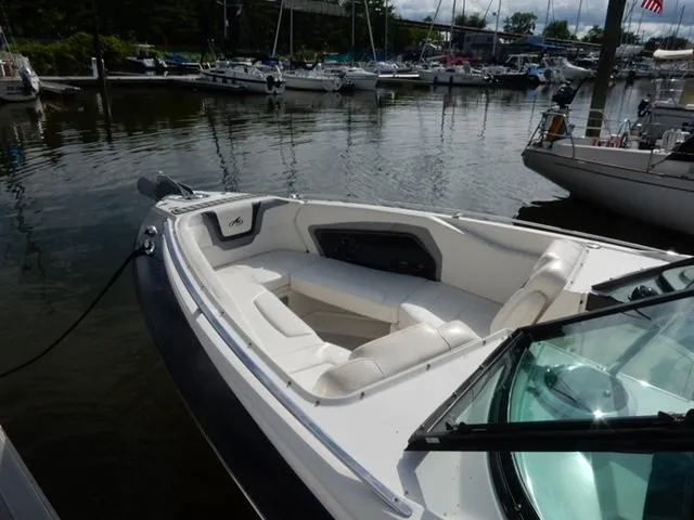 Slide: The Image of 2014 Monterey 288 Super Sport boat docked in a marina, featuring spacious seating. - 22