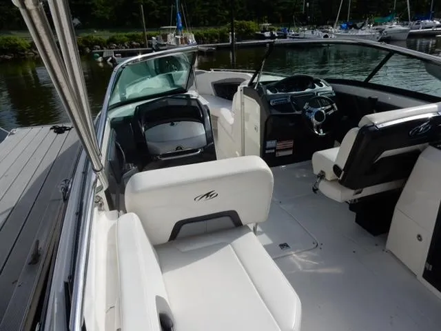 Slide: The Image of 2014 Monterey 288 Super Sport boat interior with white seating and steering console. - 26