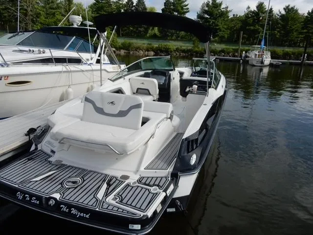 Slide: The Image of 2014 Monterey 288 Super Sport boat docked in a marina, featuring sleek design and spacious seating. - 3