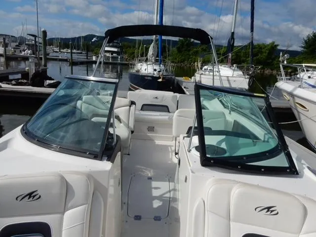 Slide: The Image of 2014 Monterey 288 Super Sport boat docked at a marina, featuring spacious seating and sleek design. - 33