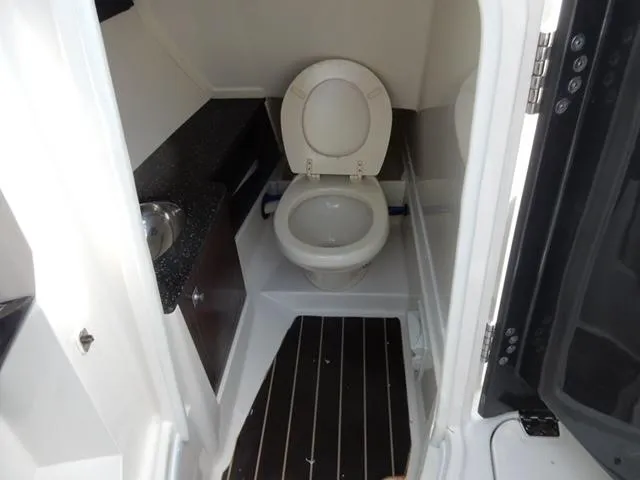 Slide: The Image of 2014 Monterey 288 Super Sport boat bathroom with toilet and sink. - 35
