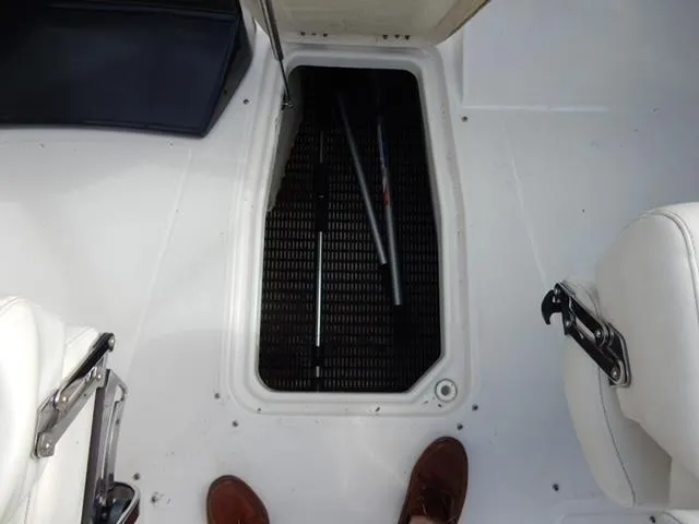 Slide: The Image of 2014 Monterey 288 Super Sport boat storage compartment with open hatch and visible interior. - 37