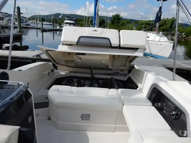 Slide: The Image of 2014 Monterey 288 Super Sport boat interior with open engine compartment at marina. - 46