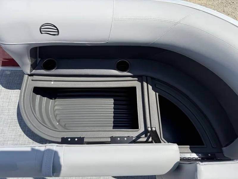 Slide: The Image of 2026 Sun Tracker PARTY BARGE® 16 DLX seating area with storage compartment and cup holders. - 7