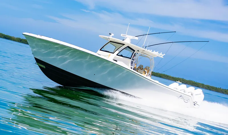 Slide: The Image of 2024 Blackwater 43 Sportfish boat cruising on clear blue water. - 10