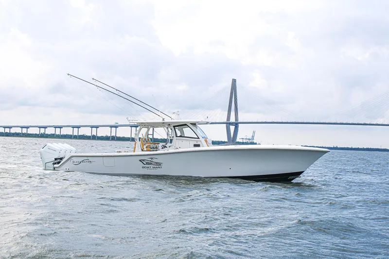 Slide: The Image of 2024 Blackwater 43 Sportfish boat on water with bridge in background. - 2