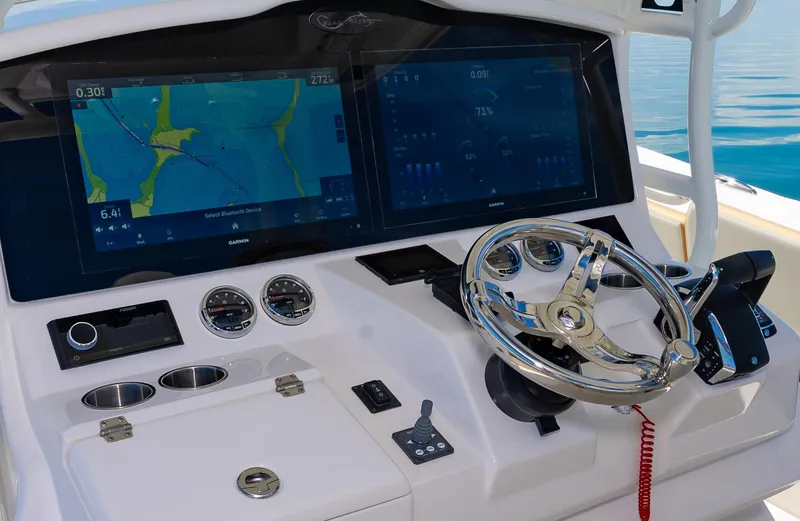 Slide: The Image of 2024 Blackwater 43 Sportfish boat helm with dual navigation screens and modern controls. - 28