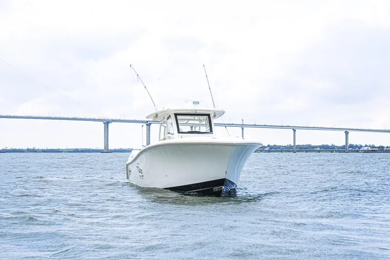 Slide: The Image of 2024 Blackwater 43 Sportfish boat on water with bridge in background. - 3