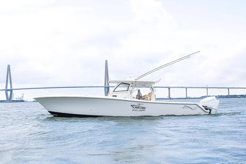 Slide: The Image of 2024 Blackwater 43 Sportfish boat cruising near a bridge on a cloudy day. - 4