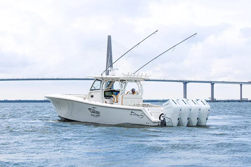 Slide: The Image of 2024 Blackwater 43 Sportfish boat cruising near a bridge on a cloudy day. - 5