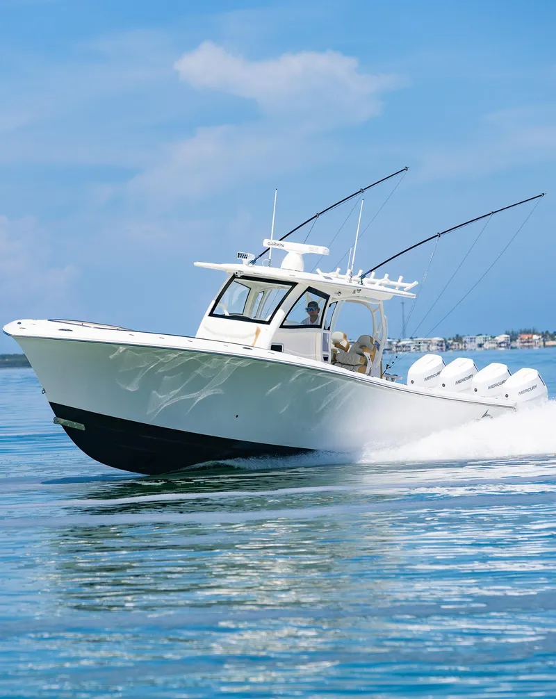 Slide: The Image of 2024 Blackwater 43 Sportfish boat cruising on clear blue water. - 7